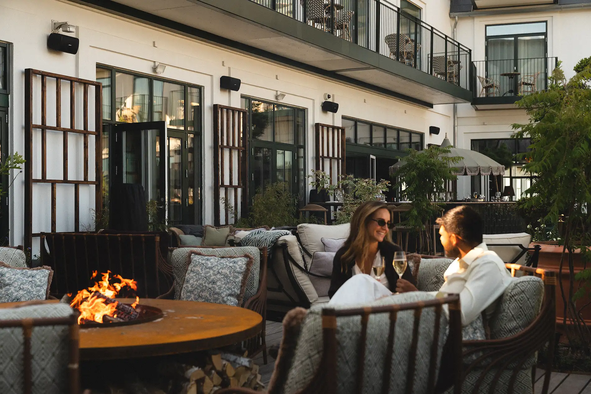 Two people enjoying a glass of champagne on the terrace.